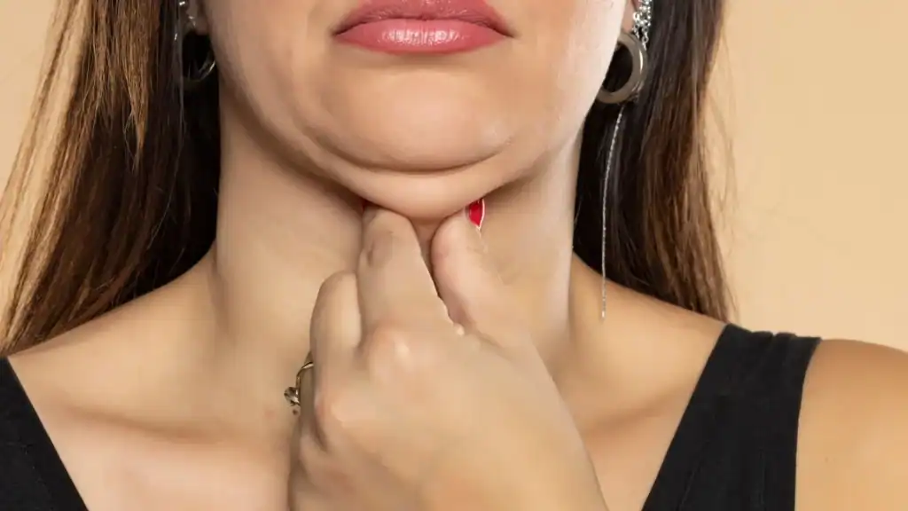 An image of a woman with double chin, sad, worried : Non Surgical Double Chin Removal Treatment in Birmingham, UK