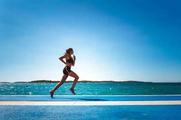Woman running showing strong leg muscle Birmingham